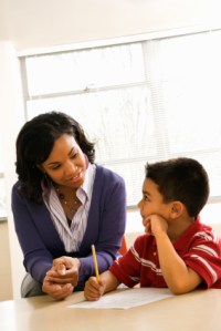 Woman Helping Boy With Schoolwork